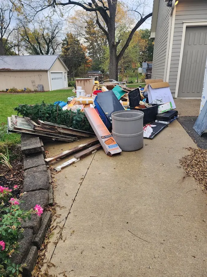 Dumpster being loaded with debris for 30 Yard Dumpster Rental in Rathdrum